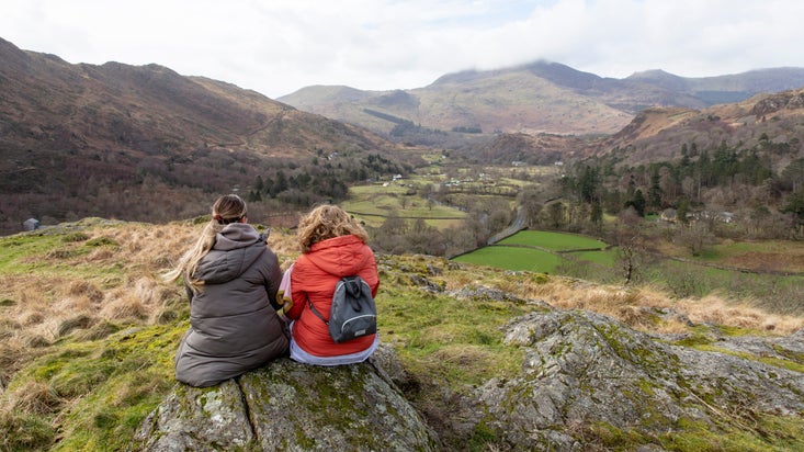 Walkers enjoying the views from the top of Dinas Emrys, Snowdonia, Wales
